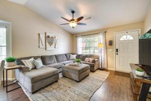 a living room with a couch and a ceiling fan at Cozy Fayetteville Vacation Rental Near Campus! in Fayetteville