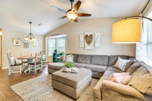 a living room with a couch and a table at Cozy Fayetteville Vacation Rental Near Campus! in Fayetteville