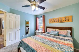 a bedroom with a bed and a ceiling fan at Cozy Fayetteville Vacation Rental Near Campus! in Fayetteville