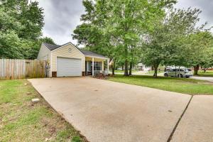 a house with a garage and a driveway at Cozy Fayetteville Vacation Rental Near Campus! in Fayetteville
