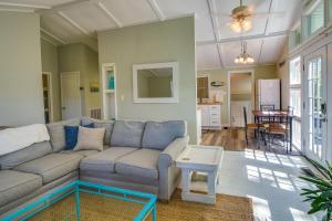 a living room with a couch and a table at Oak Island Vacation Rental - 2 Blocks to Beach! in Oak Island