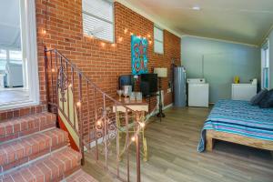 a room with a bed and a brick wall at Oak Island Vacation Rental - 2 Blocks to Beach! in Oak Island