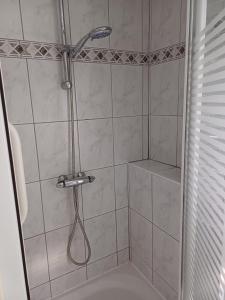 a shower with a shower head in a bathroom at Casa di Lauza in Valkenburg