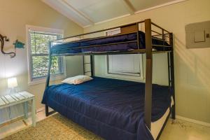 a bedroom with two bunk beds in a room at Oak Island Vacation Rental - 2 Blocks to Beach! in Oak Island