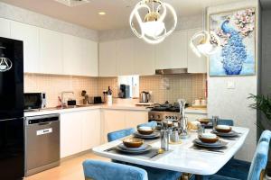 a kitchen with a table with dishes on it at Paradise on the Island - Luxurious Seaview Apartment @DubaiCreekHarbour in Dubai