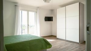 a bedroom with a bed and a large window at Tenuta Papola B&b in Brindisi