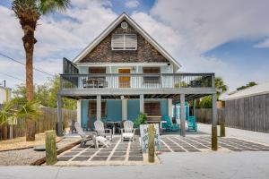 a house with a deck and a patio at PCB Group Retreat with Deck, 1 Block to Beach! in Panama City Beach