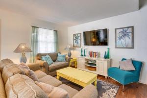 a living room with a couch and a table at PCB Group Retreat with Deck, 1 Block to Beach! in Panama City Beach