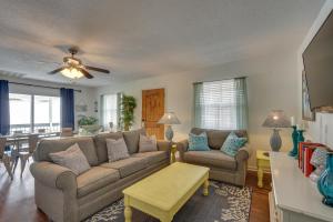 a living room with a couch and a table at PCB Group Retreat with Deck, 1 Block to Beach! in Panama City Beach