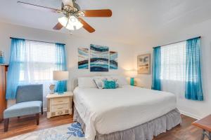 a bedroom with a bed and a ceiling fan at PCB Group Retreat with Deck, 1 Block to Beach! in Panama City Beach