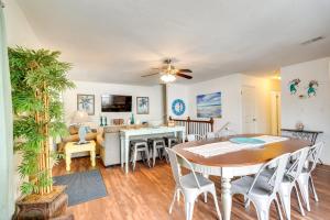 a dining room and living room with a table and chairs at PCB Group Retreat with Deck, 1 Block to Beach! in Panama City Beach