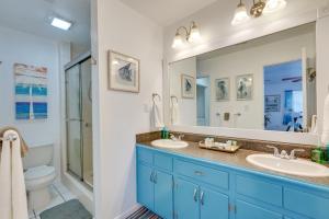 a bathroom with two sinks and a toilet and a mirror at PCB Group Retreat with Deck, 1 Block to Beach! in Panama City Beach +37 photos