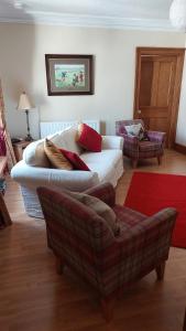 sala de estar con sofá y silla en Upper Deck, en Eyemouth