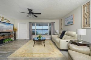 a living room with a couch and a table at Lovely Lakefront Home with Grill 7 Mi to Legoland! in Winter Haven