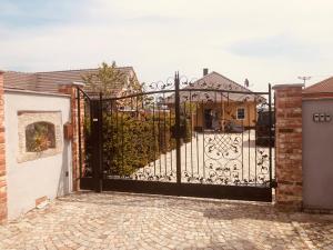 a black gate in front of a house at Altes Gewölbe mit Sauna und Whirlpool im Außenbereich in Elsterheide