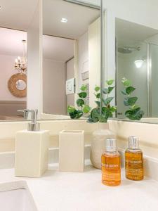 a bathroom with two bottles of essential oils on a counter at jh - Creado como un Hotel Boutique in Buenos Aires