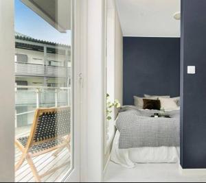 a room with a bedroom with a bed and a balcony at Northern Dreams Apartment with free parking in Tromsø