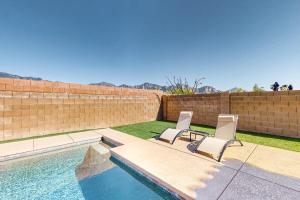 two chairs and a swimming pool in a backyard at Lemmon Vista in Oro Valley