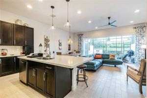 a kitchen and a living room with a couch at Pool Home Champions Gate Area with Resort Amenities Next to Disney in Davenport