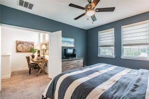 a bedroom with a bed with a ceiling fan and a desk at Pool Home Champions Gate Area with Resort Amenities Next to Disney in Davenport