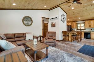 a living room with a couch and a table at Vacation Rental Cabin Near Lake Arbutus! in Hatfield