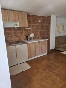 a kitchen with a sink and a stove top oven at Top Holiday Kuca sa bazenom in Lukavac