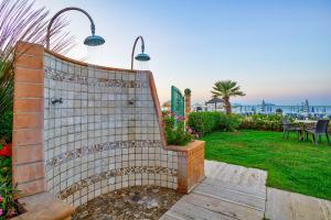 a bench in a garden with a view of the ocean at Hotel Miramare - Silvi Marina in Silvi Marina