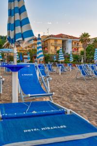 a group of chairs and umbrellas on a beach at Hotel Miramare - Silvi Marina in Silvi Marina