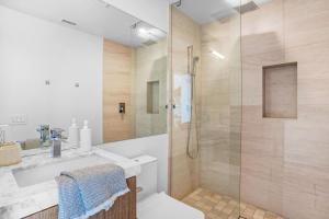 uma casa de banho com um chuveiro e um lavatório. em Experience Eco-Luxury at its Finest - Centrally Located Clea House in San Diego! em San Diego