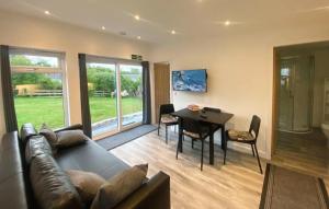 a living room with a couch and a dining room table at Ardvreck Chalet self-catering in Kyleakin