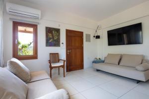 a living room with a couch and a television at Eliva house in Chania Town
