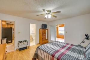 a bedroom with a bed and a ceiling fan at East Palatka Vacation Rental, Anglers Paradise in East Palatka