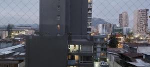 a view of a city at night with buildings at Linda habitacion in Santiago