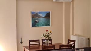a dining room with a table and a picture of a boat in the water at VILLA PAGONI Residence Selini Villas N 1 Kolymbari Chania in Kolymvari