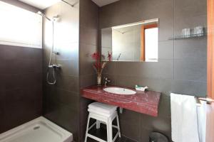 a bathroom with a sink and a mirror and a tub at Hotel Marblau Tossa in Tossa de Mar