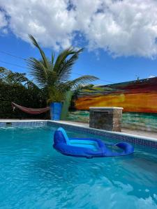a swimming pool with a blue raft in the water at 2bedroom mountain view villa #2 in Muñoz