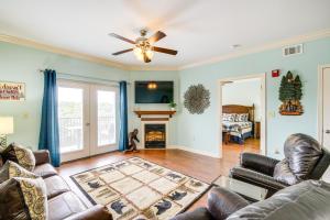 a living room with leather furniture and a fireplace at Pigeon Forge Condo with Community Amenities! in Pigeon Forge