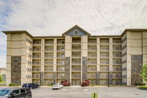 a large building with cars parked in a parking lot at Pigeon Forge Condo with Community Amenities! in Pigeon Forge