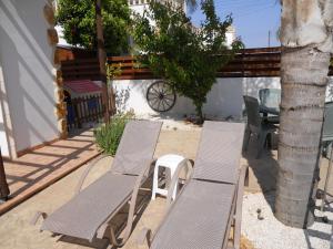 two chairs and a table and chairs on a patio at Traditional Villa Sofia in Vrysoules