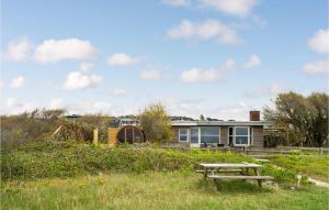 una casa con una mesa de picnic delante de ella en Stunning Home In Knebel With 3 Bedrooms, Sauna And Wifi, en Knebel