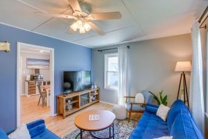 a living room with a blue couch and a ceiling fan at Sturgeon Bay Home about 6 Mi to Potawatomi State Park in Sturgeon Bay