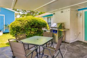 a patio with a table and chairs and a stove at Gulf Breeze Vacation Rental with Pool Access! in Gulf Breeze