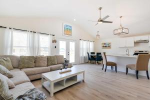 ein Wohnzimmer mit einem Sofa und einem Tisch in der Unterkunft Airy Freeport Vacation Rental with Deck! in Freeport