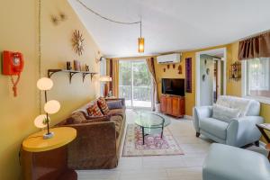 a living room with a couch and a table at Quaint Vacation Rental with Porch in Banner Elk! in Banner Elk