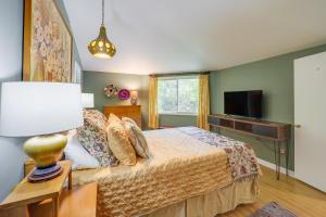 a bedroom with a bed and a flat screen tv at Quaint Vacation Rental with Porch in Banner Elk! in Banner Elk