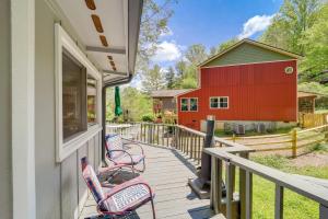 a porch with chairs and a red barn at Quaint Vacation Rental with Porch in Banner Elk! in Banner Elk