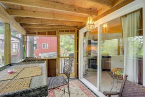 a screened in porch with a table and chairs at Quaint Vacation Rental with Porch in Banner Elk! in Banner Elk