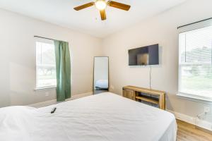 a white bedroom with a bed and a tv at Texas Family Home with Hot Tub 1 Mi to Lake Whitney in Whitney