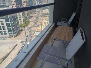 a desk and chair in a room with a window at Escan Marina Tower Apartment in Dubai