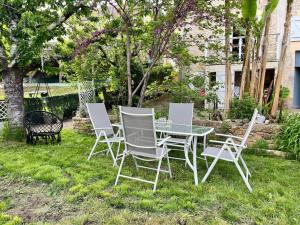 a table and chairs sitting in the grass at Le Périgourdin in Saint-Cyprien